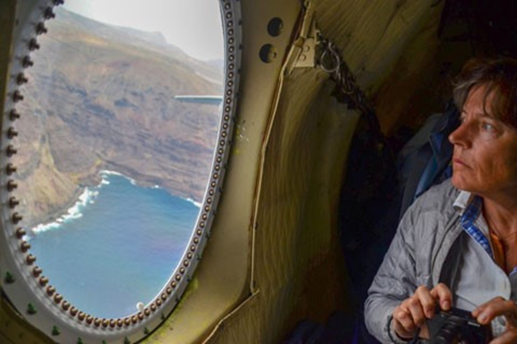 Cloud researcher Paquita Zuidema takes in the view from a research aircraft in 2018 during the NASA Observations of Aerosols above Clouds and their Interactions (ORACLES) field campaign. 