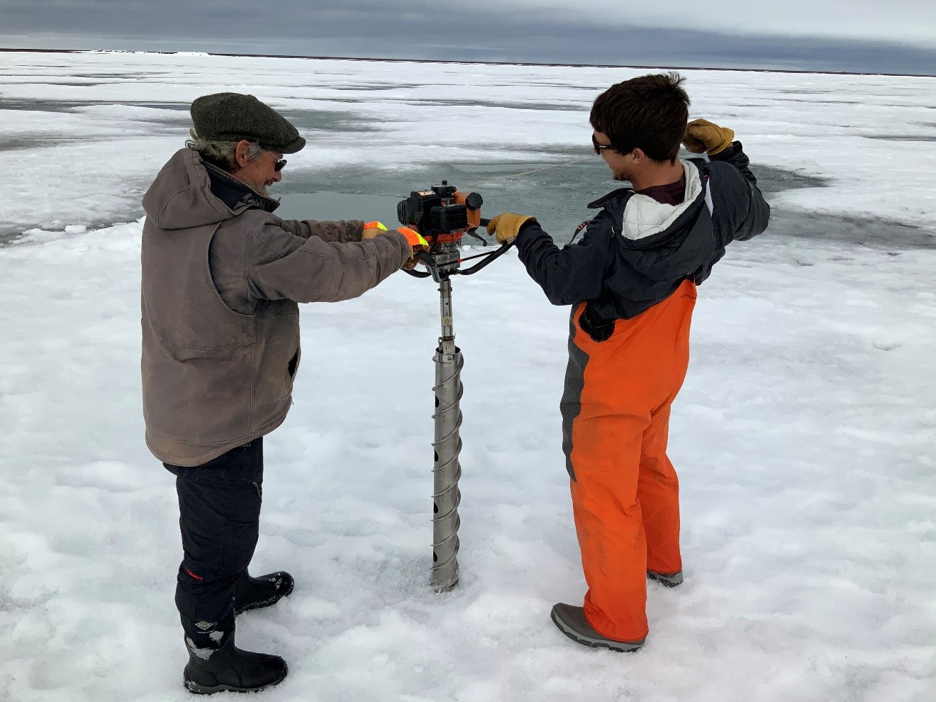 Out on the ice during SALVO fieldwork in the spring of 2019, Sturm (left) helps drill for an ice core. With him is University of Alaska Fairbanks technician Trevor Grams. 