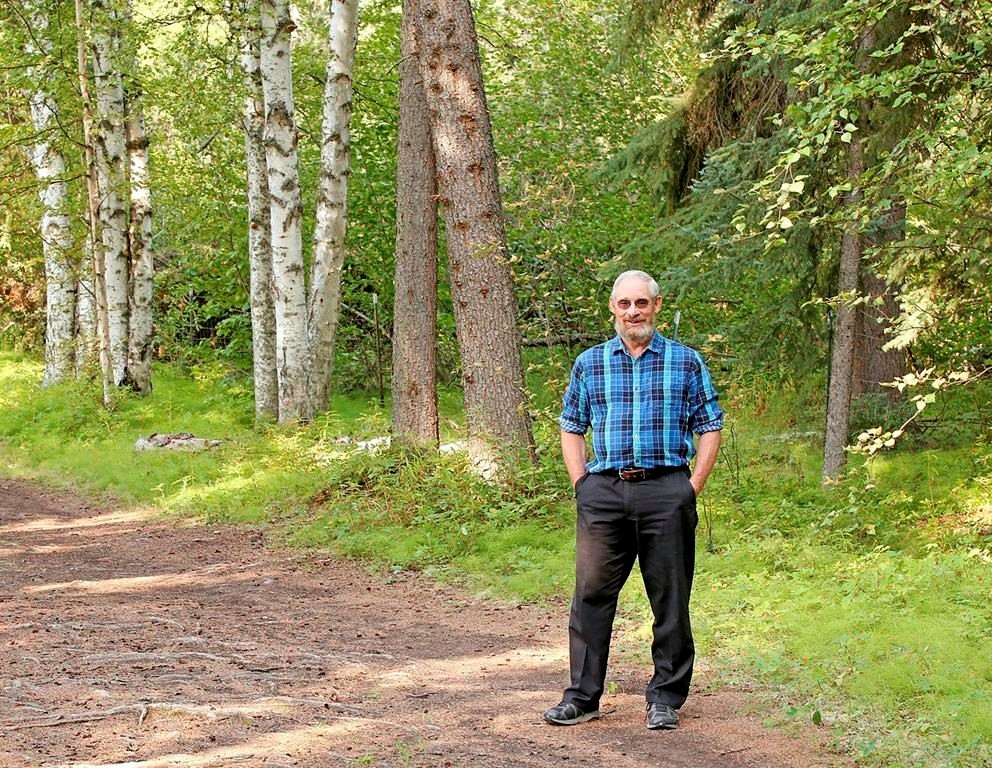 In a rare snowless moment, Sturm pauses on a forested path in Fairbanks. He calls summer in Alaska “the unusual season.” 