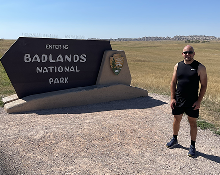 Dzambo, a travel and hiking enthusiast, looks ready in this 2022 photo to take on Badlands National Park in South Dakota.