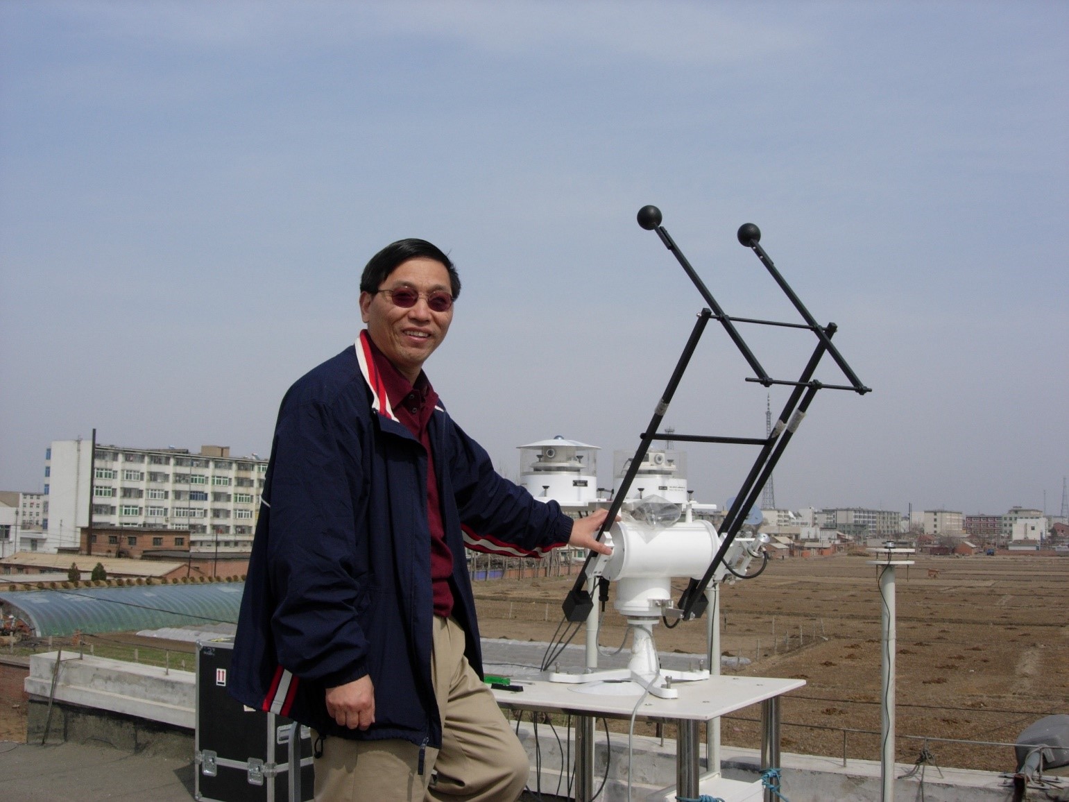 Zhanqing Li poses at a field site in China during an ARM field campaign he led in 2008. Researchers investigated the effects of aerosols on what was then that country’s fast-changing atmosphere. Photo is courtesy of Li.