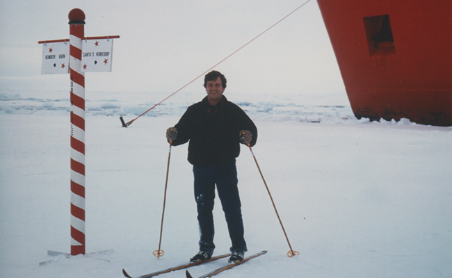 In 1994, during a research trip, Lubin paused by a pole at the North Pole, ski poles in hand. Photo courtesy of Lubin.
